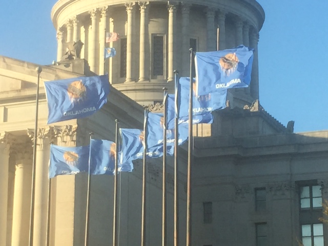 OKC flags blowing in the wind at capitol