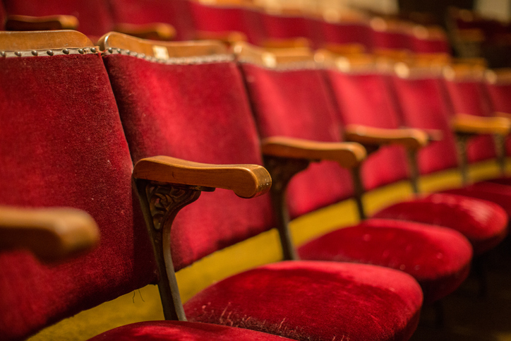 Old fashion cinema theatre seats with wooden arms flip-up seats