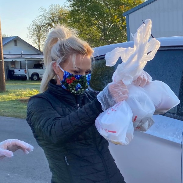 Joleen Chaney wearing mask and gloves to hand out meals to Rush Springs students