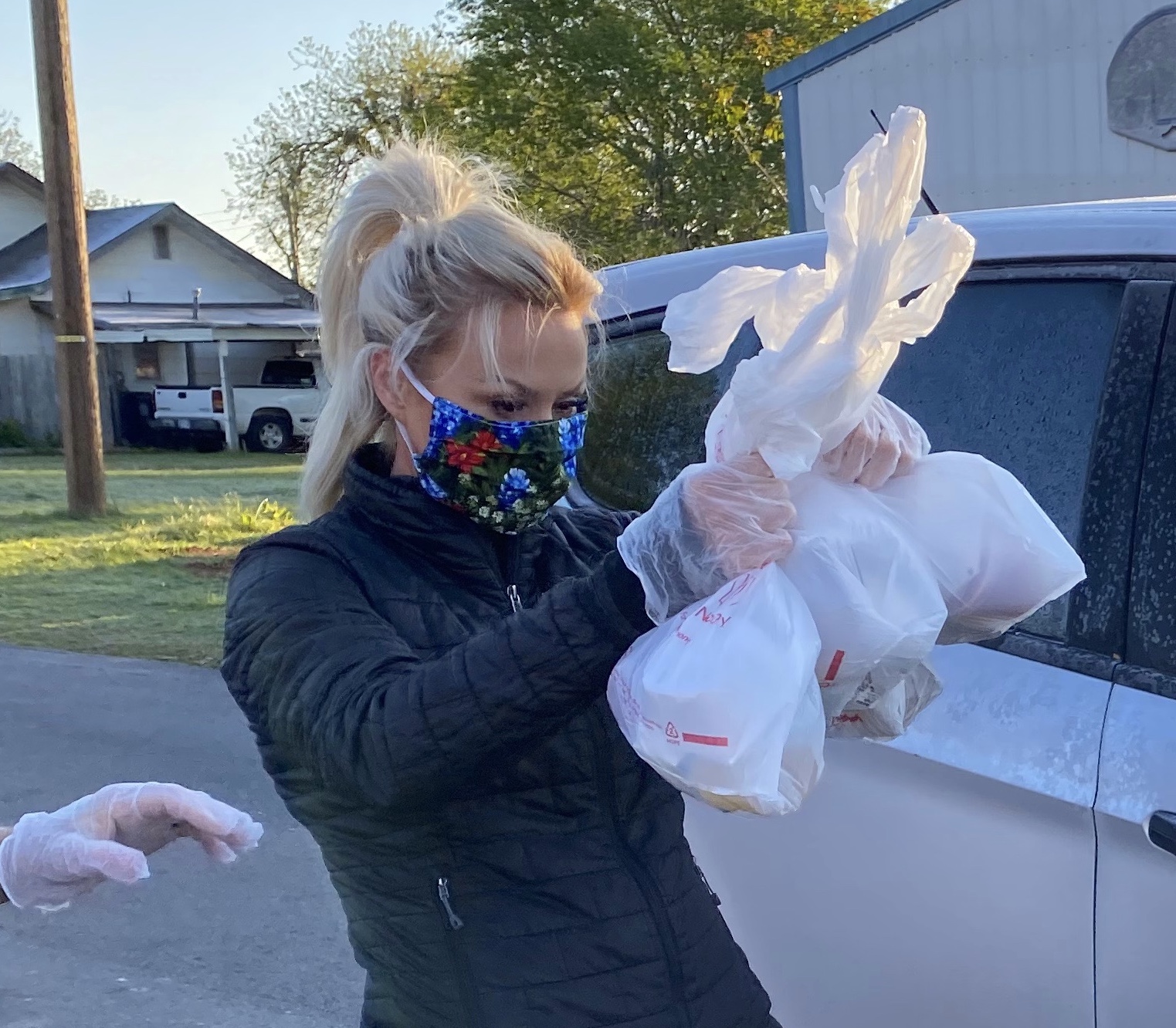 Joleen Chaney wearing mask and gloves to hand out meals to Rush Springs students