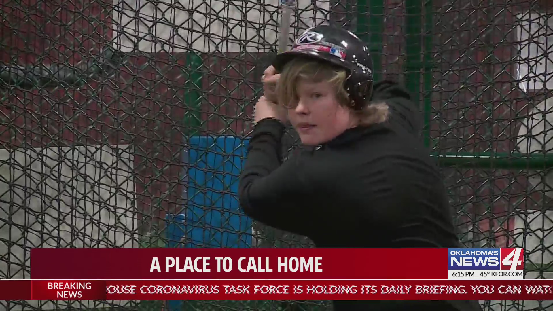 teen boy takes batting stance in batter's cage