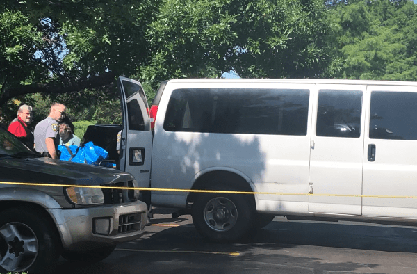 Picture of crime tape and police van after a body is found in NW OKC